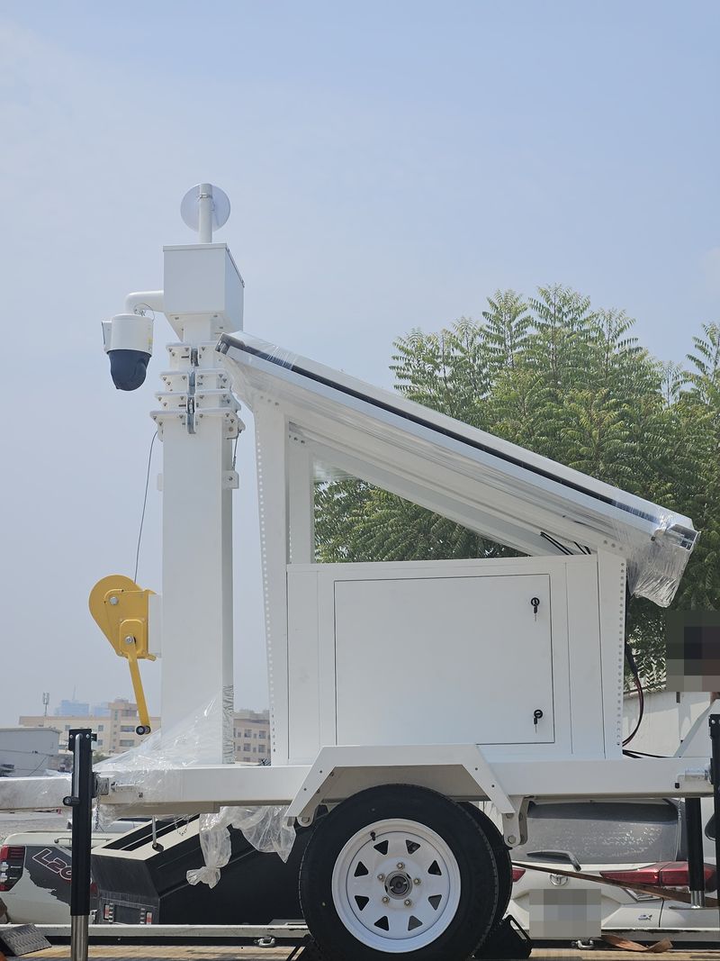 Mobile solar CCTV trolley with telescopic mast, PTZ camera and wireless antenna on a wheeled trailer